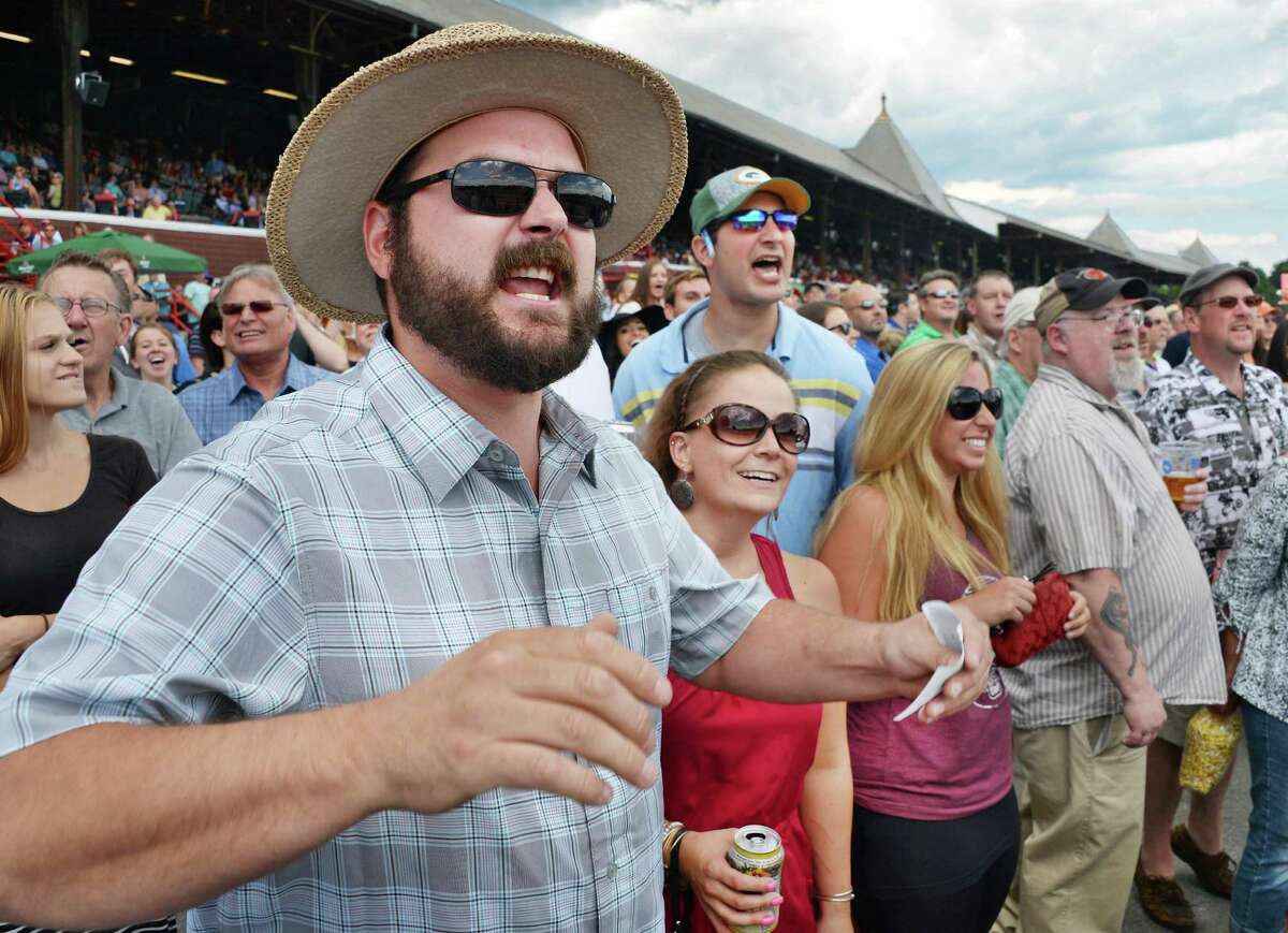 Ryan Skrocki, left, of Adams, Mass., urges on his pick in the first race at Saratoga Race Course Friday July 24, 2015 in Saratoga Springs, NY. (John Carl D'Annibale / Times Union)