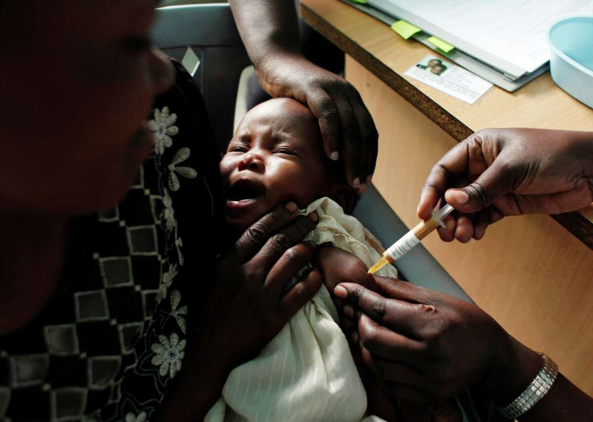 FILE - In this Oct. 30, 2009 file photo, a mother holds her baby as she receives a new malaria vaccine as part of a trial at the Walter Reed Project Research Center in Kombewa in Western Kenya. The European Medicines Agency is recommending that the worldâs leading malaria vaccine be licensed even though it is only about 30 percent effective and that protection fades over time. In a statement published on Friday, July 24, 2015, the agency said it had âadopted a positive scientific opinionâ for the vaccineâs use outside the European Union, a regulatory process that helps speed new medicines to the market. The vaccine, known as Mosquirix and made by GlaxoSmithKline, protects only about one-third of children though it might help protect some kids from getting the parasitic disease. (AP Photo/Karel Prinsloo, File)