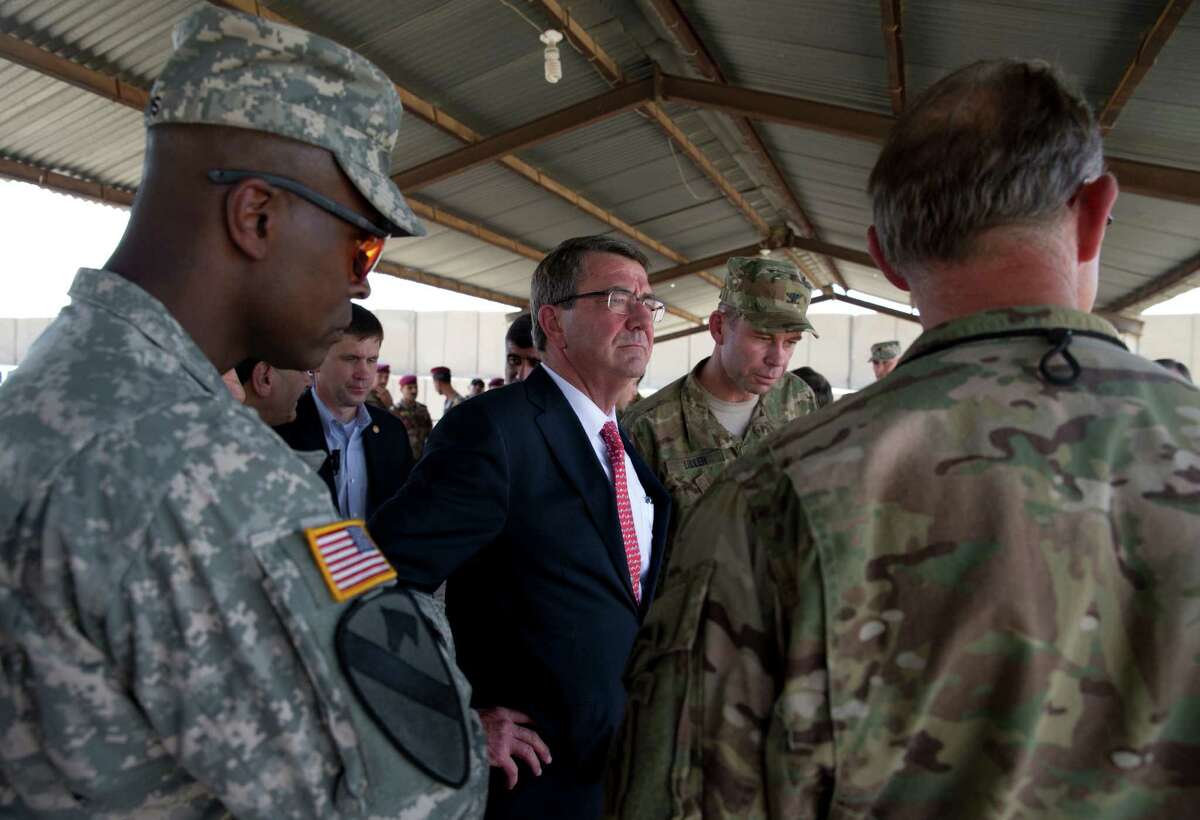 U.S. Defense Secretary Ash Carter, center, stands with Col. Otto Liller, commander, 1st Special Forces Group (Airborne), second from right, as he observes Iraqi Counter Terrorism Service forces participate in a training exercise at the Iraqi Counter Terrorism Service Academy on the Baghdad Airport Complex in Baghdad, Iraq, Thursday, July 23, 2015. Carter is on a weeklong tour of the Middle East focused on reassuring allies about Iran and assessing progress in the coalition campaign against the Islamic State in Syria and Iraq. (AP Photo/Carolyn Kaster, Pool)