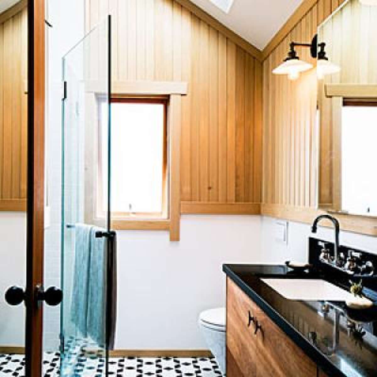 Count inches When photographer Aya Brackett added a master suite to her Oakland home, she was literally counting-and saving-inches. She gained some space by mounting the faucet on the wall rather than the vanity top, choosing an in-wall tank toilet, recessing the medicine cabinet into the wall, and swapping a shower curtain for glass doors. The transparency from the glass and light from the skylight also help to make the tight space seem large. See the rest of Aya's space-savvy master suite