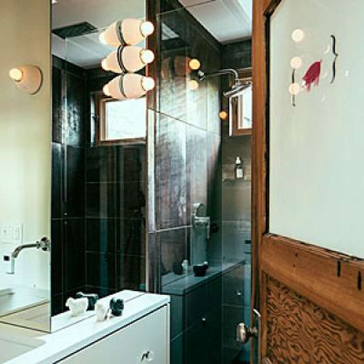 Reflect everything Homeowner Daniel Thomas ditched the painted walls in his Portland Victorian for walls covered in mirrors. Even though the bathroom is barely big enough for the door to swing open, the mirrors trick you into thinking it's twice the size. Also helping: the glass door to the shower and glass ceiling that reveals rafters above. See the rest of this modernized Victorian home Read more: 14 new ways to revamp your bathroom