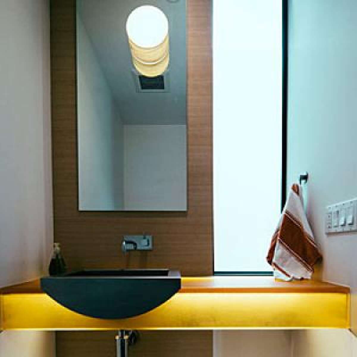 Turn on the light show This Boulder townhome doesn't have a lot of room, so the owner played up light everywhere she could: with a frosted glass window, a translucent resin vanity that glows in the light, and a mirror that also reflects the light from the fixture. Read more: 15 genius space-saving room ideas