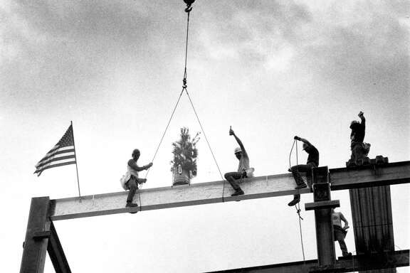Oct. 22, 1982: Construction workers celebrate with champagne after setting the last steel beam on the San Francisco ballet building.
