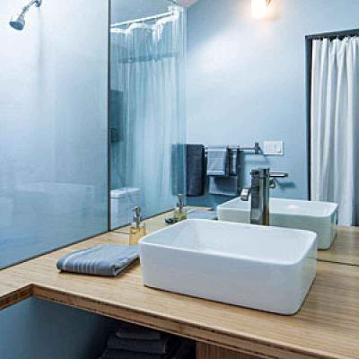 Open up Portlander Susan Moray built this teeny tiny bathroom in a small cottage in her backyard that she eventually plans to move into. For good visual flow in the bathroom, she installed a glass wall between the shower and the sink, and opted for bamboo shelves instead of a cabinet. "We wanted to avoid chopping up space wherever possible," says Moray. Of course, not everything is display-worthy-a closet just outside the bathroom provides additional storage for toiletries, and a curtain opposite the sink hides a washer-dryer. Read more: 14 new ways to revamp your bathroom