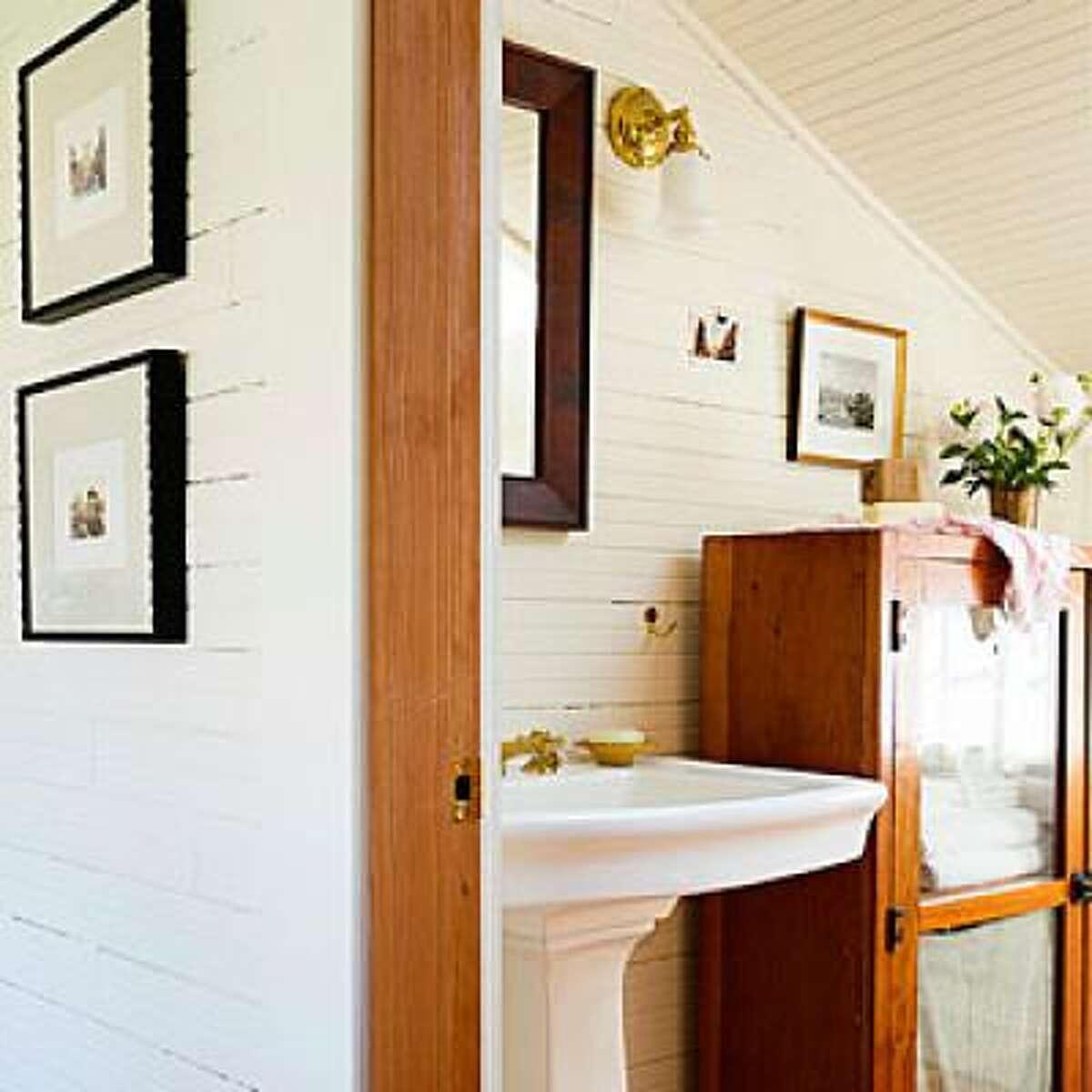 Help awkward spaces Architects Melody and Brian Emerick remodeled their Oregon beach shack but kept the steep roof line in their attic master suite, which made space an issue in the bathroom. They made the most of it by substituting furniture pieces for a traditional vanity or built-in shelving, and painting the walls and ceiling the same color for the illusion of more light. See the amazing before and after of this house