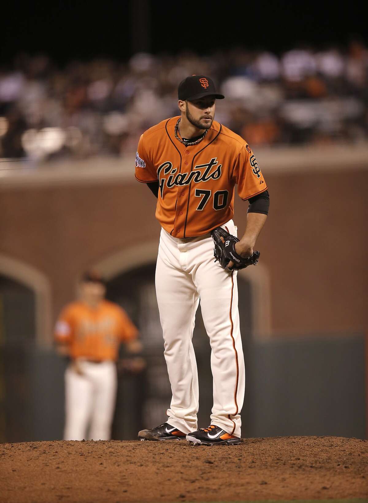 Giants' pitcher George Kontos, 70 looks in for the signs as he throws in the seventh inning, as the San Francisco Giants take on the Oakland Athletics at AT&T Park in San Francisco, Calif. on Fri. July 24, 2015.