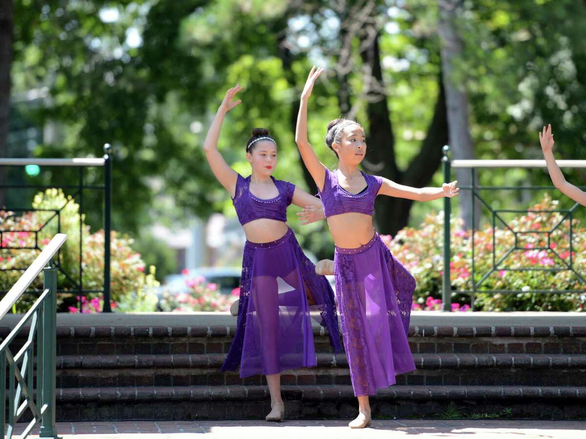 Sydnew Anderson, 13, of Stratford, and Ming-May Hu, 14, of Milford, perform a lyrical dance routine with other students from The Connecticut Dance Conservatory to the song "Trouble" Saturday, July 25, 2015, on Paradise Green in Stratford, Conn. Get Healthy CT, the regional wellness coalition of hospitals, hosted the free day of dancing with demos, prize drawings and giveaways, in celebration of National Dance Day.