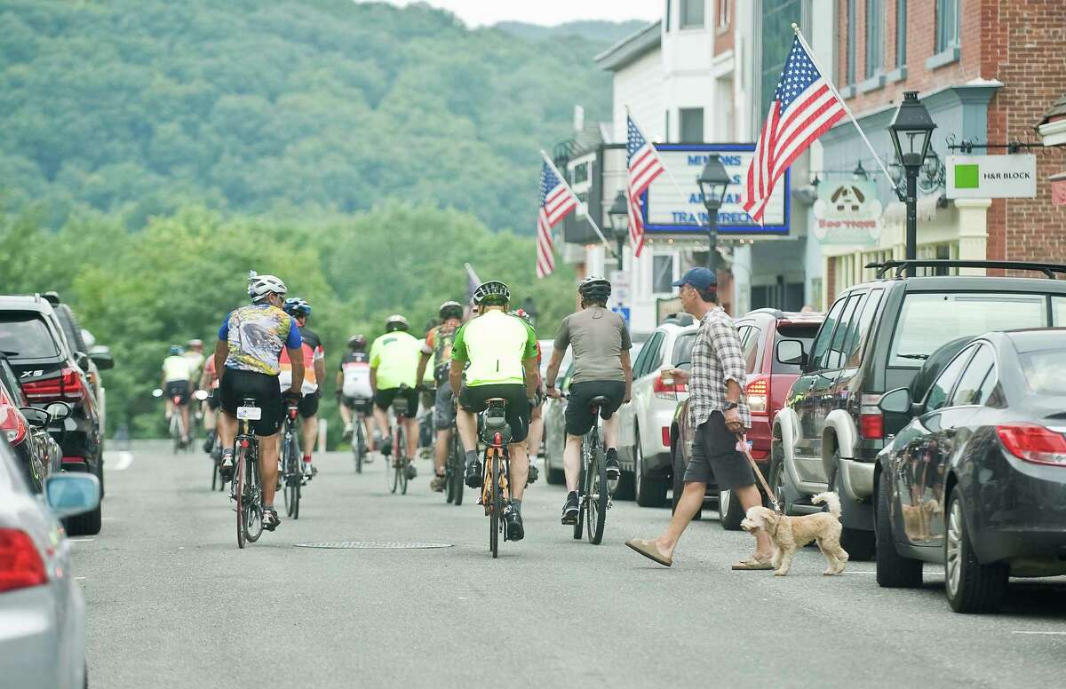 Cyclists head out from the New Milford Green to continue their cycling ride on Sunday.