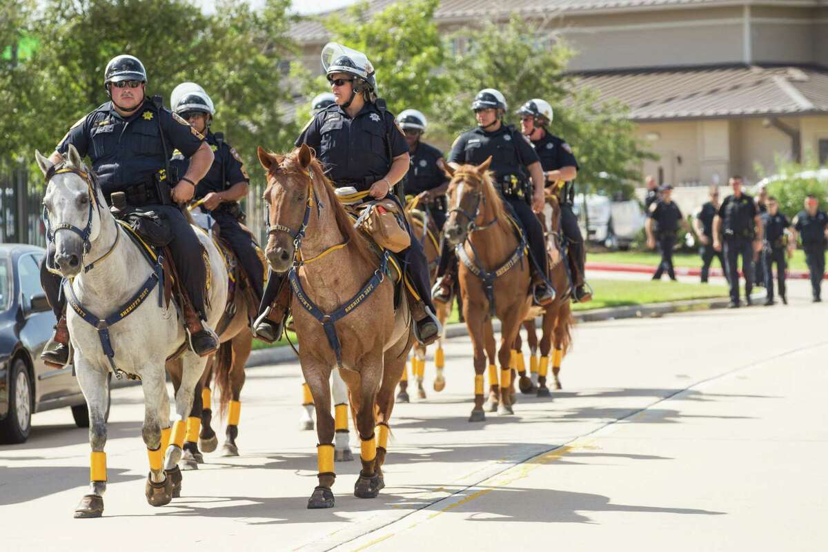 Harris County Sheriff's deputies arrive on horseback before a protest by African-American community leaders calling for the firing and indictment of State Trooper Brian Encinia on Sunday, July 26, 2015, in Katy. The demonstrators gathered at an apartment complex, lined by Harris County deputies on horseback, to protest against the trooper who arrested Sandra Bland.