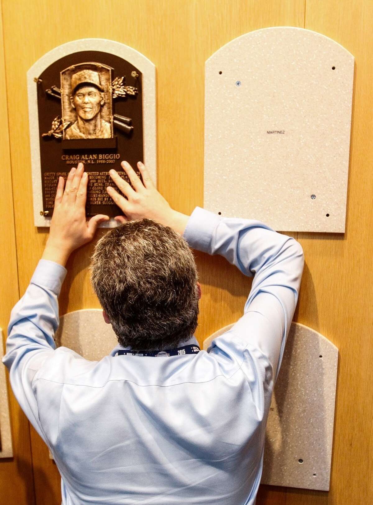 A Baseball Hall of Fame employee secures Craig Biggio's Hall of Fame plaque on it's spot in the museum, Sunday, July 25, 2015, in Cooperstown NY. (Karen Warren/Houston Chronicle)