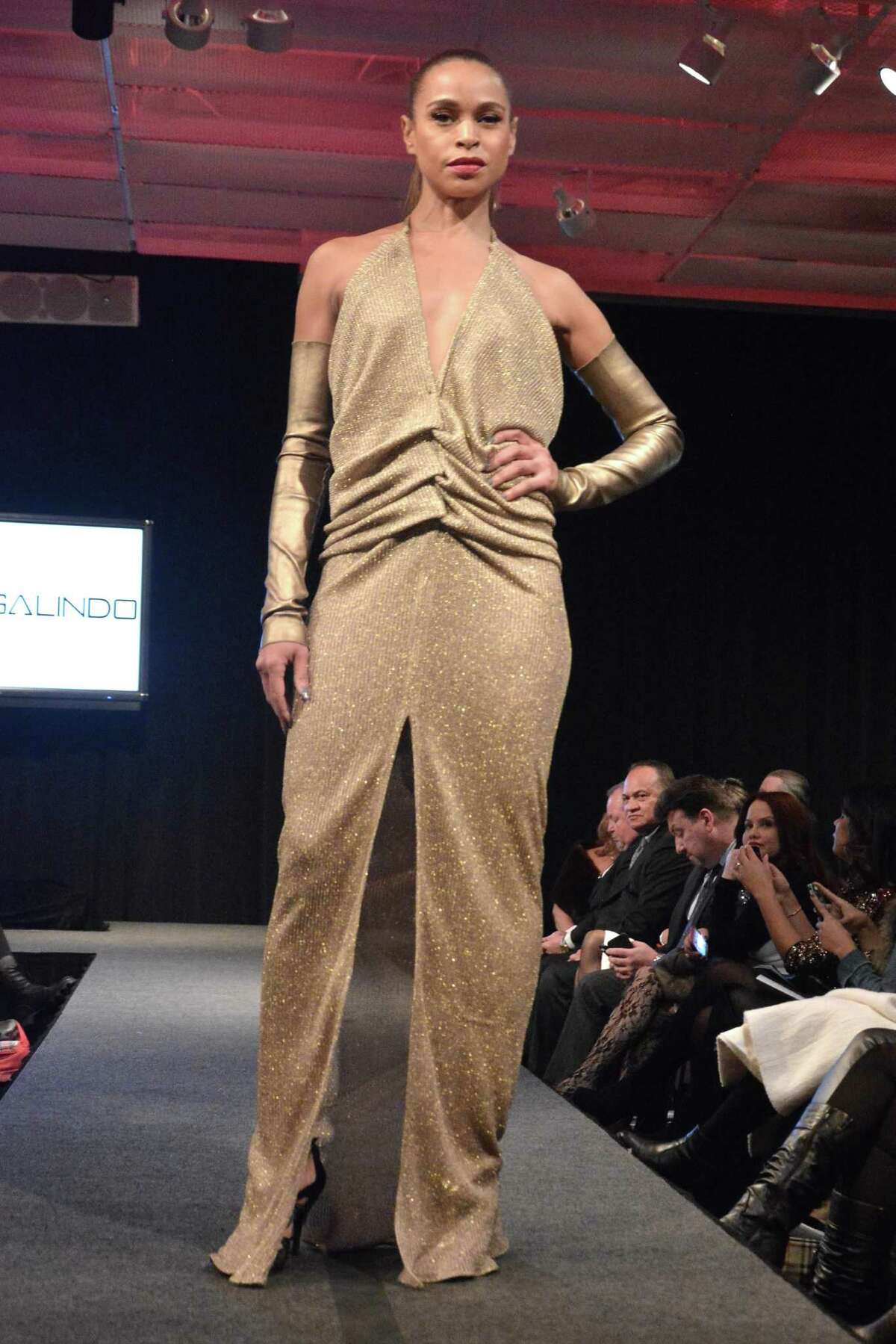 Sexy draping and modern shapes are signatures of Cesar Galindo’s glamorous designs for today’s woman. The Houston-born designer and New York Fashion Week regular is bringing his fall/winter 2015 collection, as seen in this look, in a free fashion show July 30 at San Antonio’s St. Anthony Hotel.