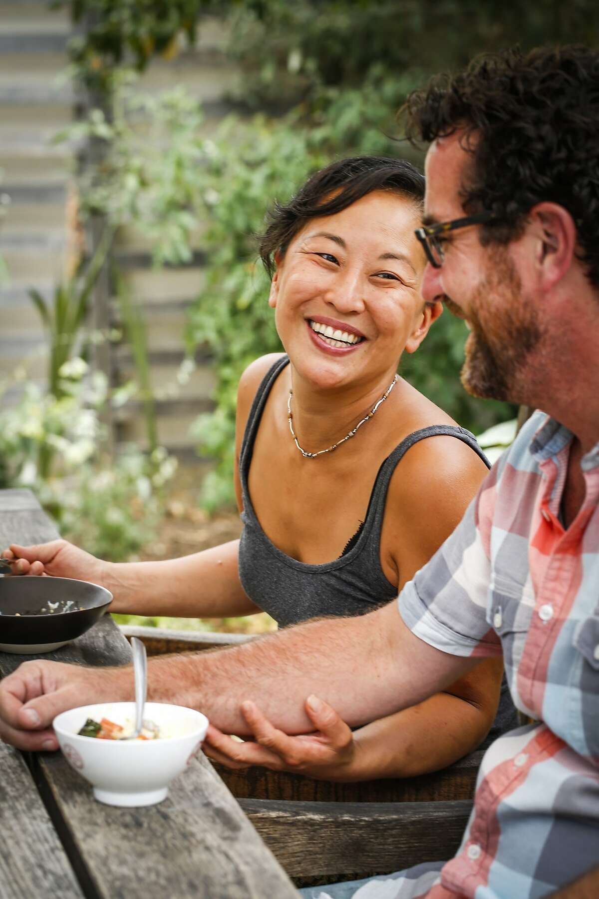 Julya Shin of Pizzaiolo and her partner, Corin Weihemuller, enjoy lunch in their garden at their home on Monday, July 20, 2015 in Oakland, Calif.