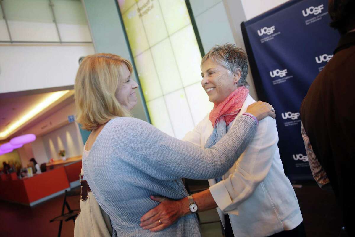Barbara French (right), UCSF’s vice chancellor for university relations, embraces Mindy Magnusson, the mother of a patient at UCSF Benioff Children’s Hospital, after a news conference on the Warriors’ arena plan on July 27, 2015.