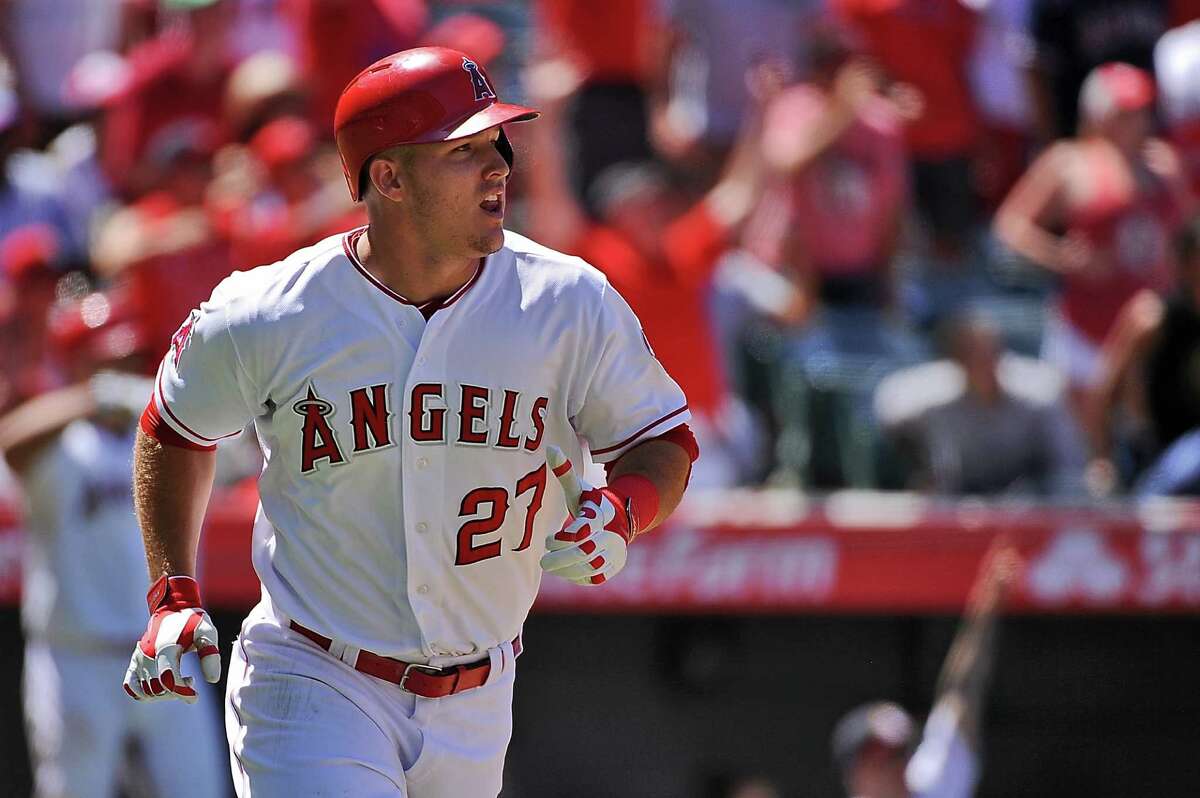 ANAHEIM, CA - JULY 26: Mike Trout #27 of the Los Angeles Angels of Anaheim watches his grand slam home run as he runs to first base in the sixth inning during a game against the Texas Rangers at Angel Stadium of Anaheim on July 26, 2015 in Anaheim, California. (Photo by Jonathan Moore/Getty Images)