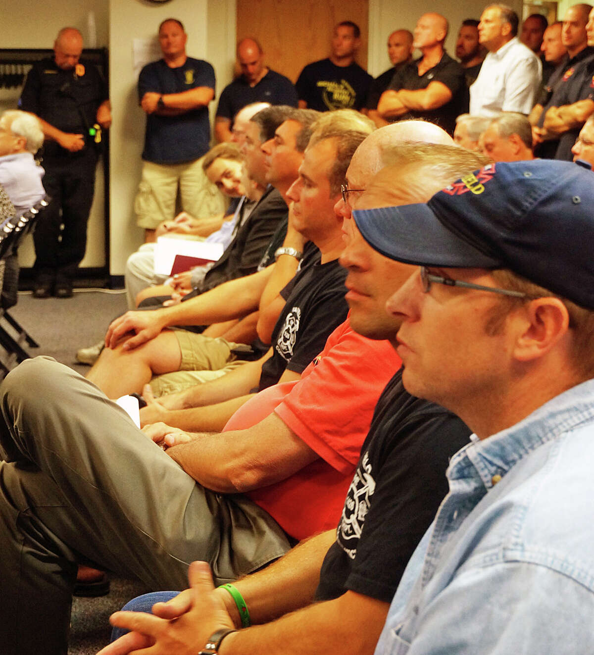 Firefighters and police officers packed Monday's Representative Town Meeting where they saw their respective contracts approved.