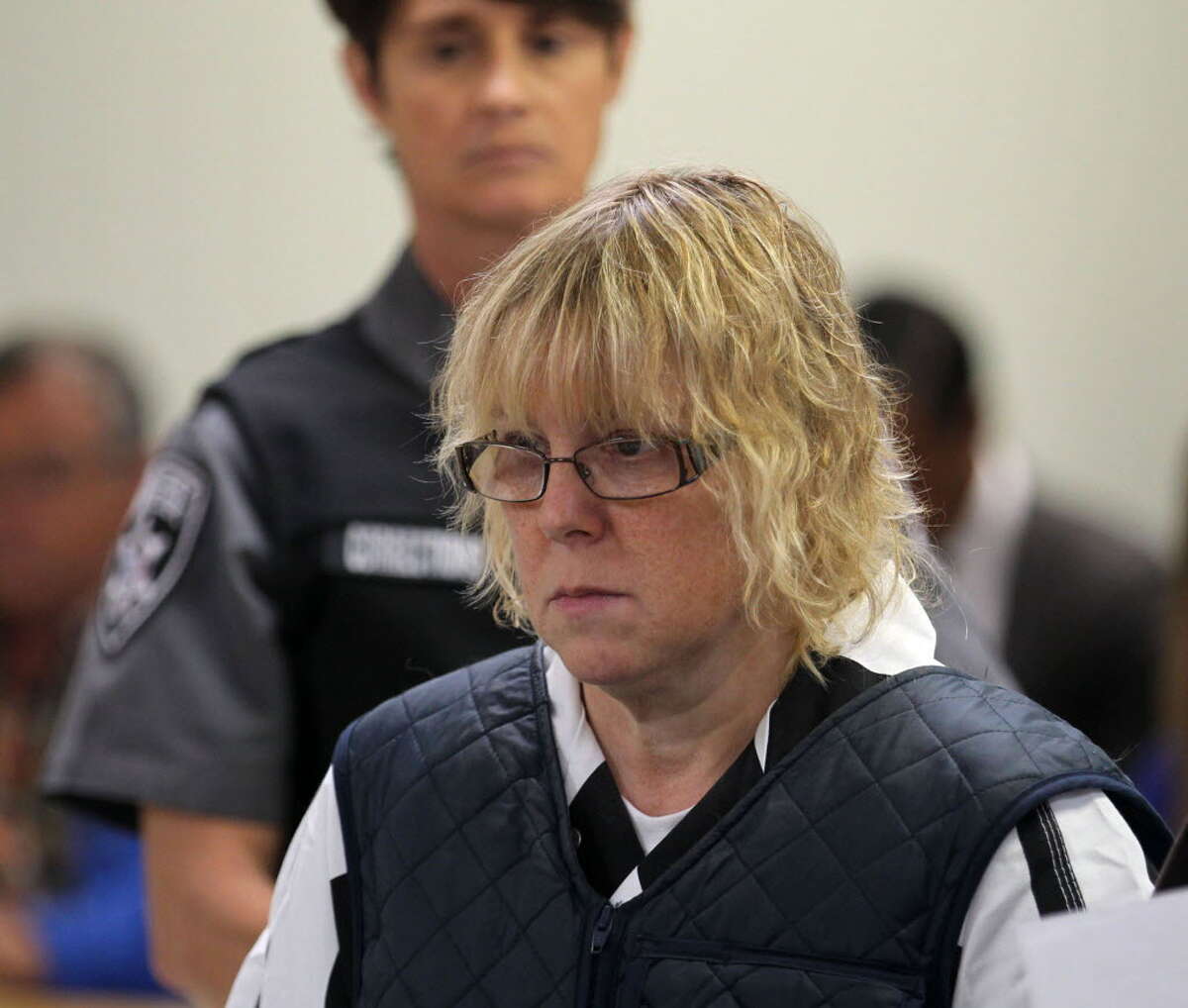 In this June 15, 2015, file photo, Joyce Mitchell appears before Judge Mark Rogers in Plattsburgh (N.Y.) City Court for a hearing. She is charged with helping Richard Matt and David Sweat escape from the Clinton Correctional Facility on June 6. While Richard Matt and David Sweat counted their final hours to freedom, prison tailor-shop instructor Mitchell was heading to a hospital with chest pains driven by a panic attack. She was leaving the hospital when she learned that Matt and Sweat were on the loose and that state police were looking for her and her husband, Lyle, a fellow industrial instructor at the prison. (G.N. Miller/NY Post via AP, Pool, File)