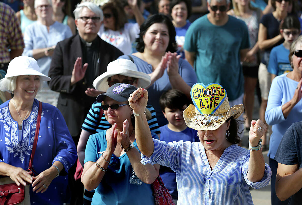 Kathy Culver, right, of Austin, pumps her fists as she and close to 130 other supporters of Texas Alliance for Life attend an anti-abortion rally at the Texas Capitol on Tuesday, July 28, 2015, in Austin, Texas.