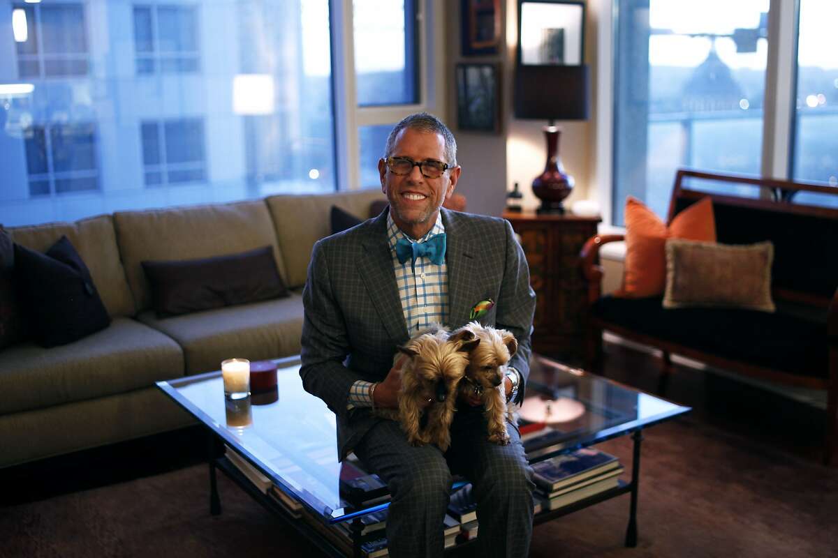 Andrew Freeman sits with his Yorkie dogs, Daisy and Tulip, within his condo on the 22nd floor of the Soma Grand. Freeman is the owner of Andrew Freeman & Co., a restaurant and hospitality consulting business in San Francisco. He will be appearing on an upcoming episode of "Million Dollar Listing San Francisco."