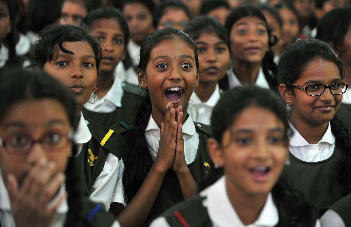 Indian schoolchildren react after watching a tiger on a giant screen during a "Kids for Tigers" programme on the eve of World Tiger Day at Hyderabad Public School in Hyderabad on July 28, 2015. World Tiger Day, is an annual celebration to raise awareness aimed at educating children about tiger conservation, held annually on July 29. 