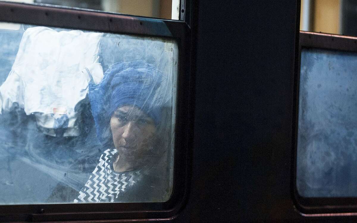 A migrant woman sits in a coach at a train headed to Serbia in the town of Gevgelija on July 27, 2015, on the Macedonian-Greek border. The migrants, among them children and elderly people are trying to cross Macedonia and Serbia and enter the EU via Hungary. Hungarian authorities started building a fence along the country's border with Serbia earlier this week to halt the migrant influx.