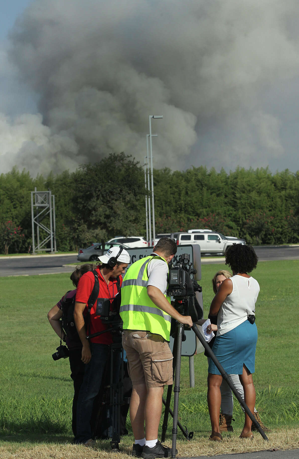 A large plume of smoke ascends skyward Wednesday July 29, 2015 from the CMC Steel Texas plant near Seguin, Texas after a fire started there about 5:30 a.m.. According to City of Seguin Public Information Officer Morgan Ash, the source of the fire may have been an automobile. Ash said 15 local fire departments are working to extinguish the fire at the scrap metal recycling plant and there have been no injuries or evacuations associated with the fire.