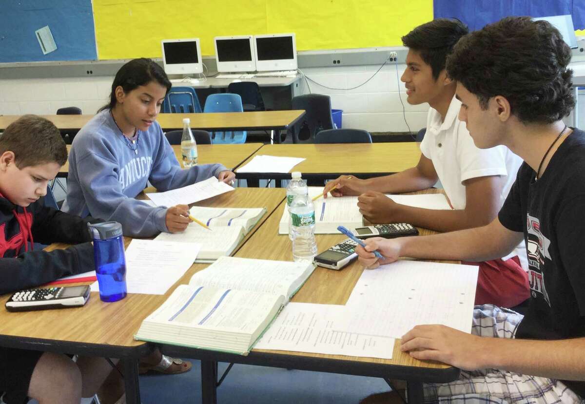 Greenwich students work on trigonometry problems during their Bridge to Honors Pre-Calculus on the opening day of summer school at Central Middle School in Greenwich, Conn. Monday, July 6, 2015.