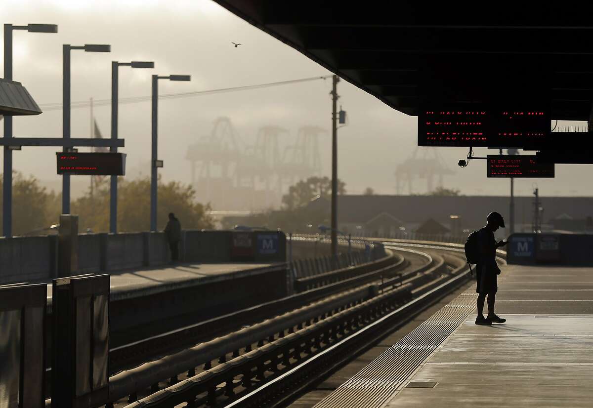 A BART passenger waits on the platform at West Oakland BART station for a west-bound train in Oakland, Calif., on Wednesday, July 29, 2015. BART shuts down the Transbay Tube for work on the West Oakland approach to the tube over the weekend of August 1st and 2nd. Trains will continue to run on either side of the bay, but will be turned around at Embarcadero station or from west Oakland, where the train descends into the tube.