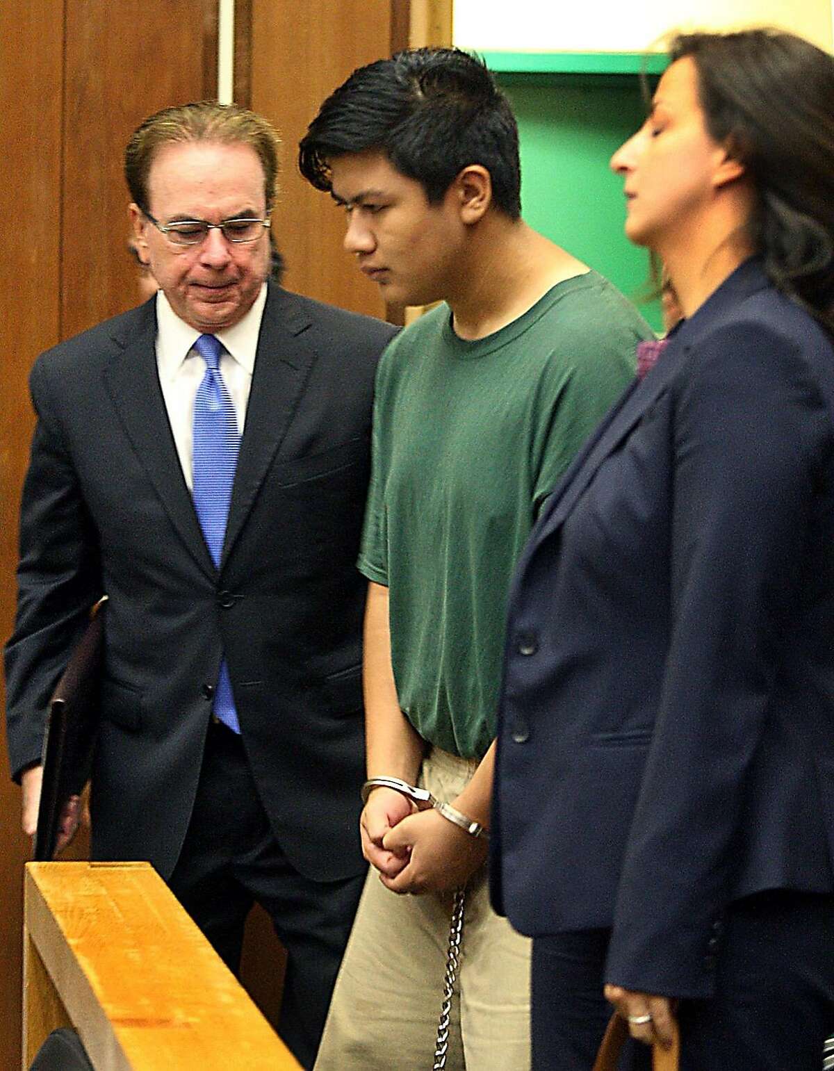 Adrian Jerry Gonzalez, center, is flanked by public defender Larry Biggam and attorney Leila Sayar as they enter the courtroom Thursday, July 30, 2015 where his arraignment was delayed in Santa Cruz, Calif. Gonzalez charged with murder, kidnapping and rape in the death of 8-year-old Madyson Middleton, in an artists' complex in the California beach town. 