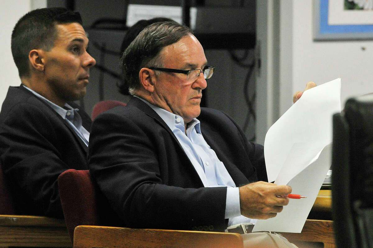 Al Barbarotta, CEO of AFB Construction Management, looks over papers during a Board of Education meeting Tuesday, when board members extended his facilities management contract by one year.