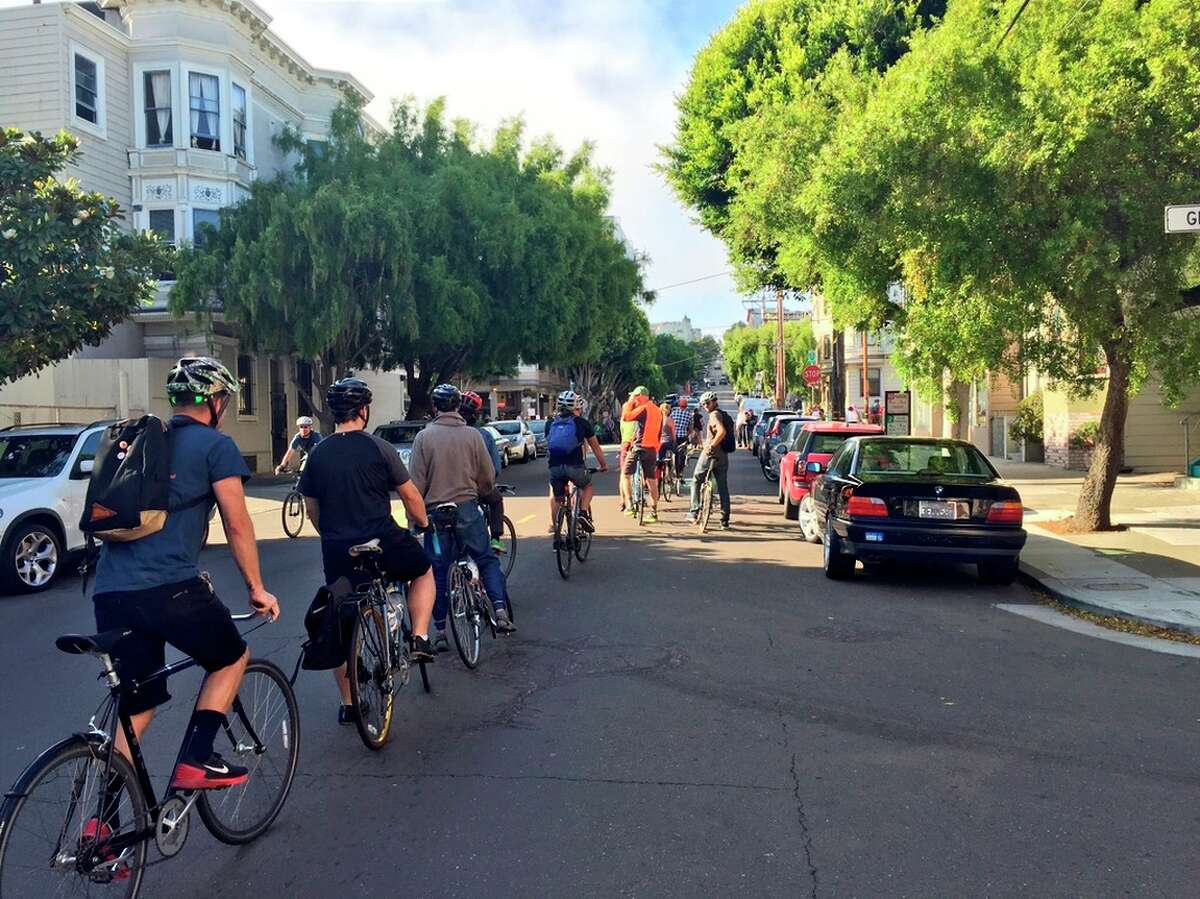 A group of bicyclists rides single file along Steiner Street on Wednesday as part of a protest over enforcement of traffic laws on a popular bike route.