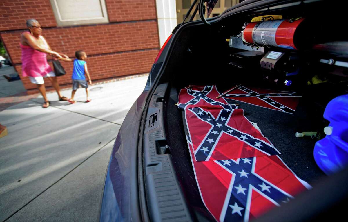 Confederate flags sit in a police car as tourists pass Atlanta’s Ebenezer Baptist Church, where Martin Luther King Jr. preached. Also nearby is the home were King lived for the first 12 years of his life.