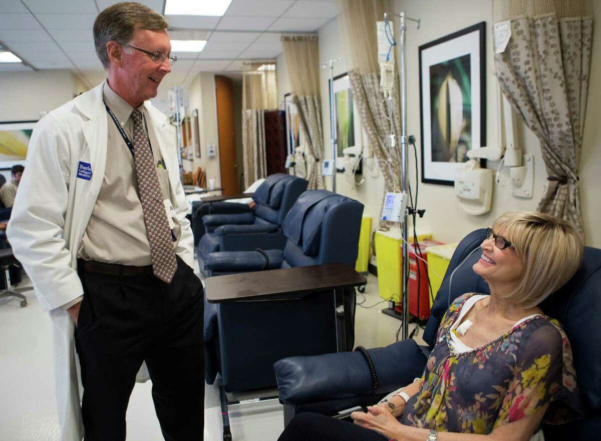 Dr. Kent Osborne, director of Baylor's cancer center, visits patient Carole Roush. He says the center's new designation will improve patient access to state-of-the-art clinical care.