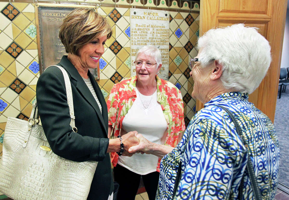 City manager Sheryl Sculley greets sister Josephine Murray (right) and sister Gabriella Lohan from the Sisters of the Holy as members of COPS and METRO gather at City Hall to express their approval of a proposed hike in the minimum wage for San Antonio on July 31, 2015. Sculley gave her approval of the change today.