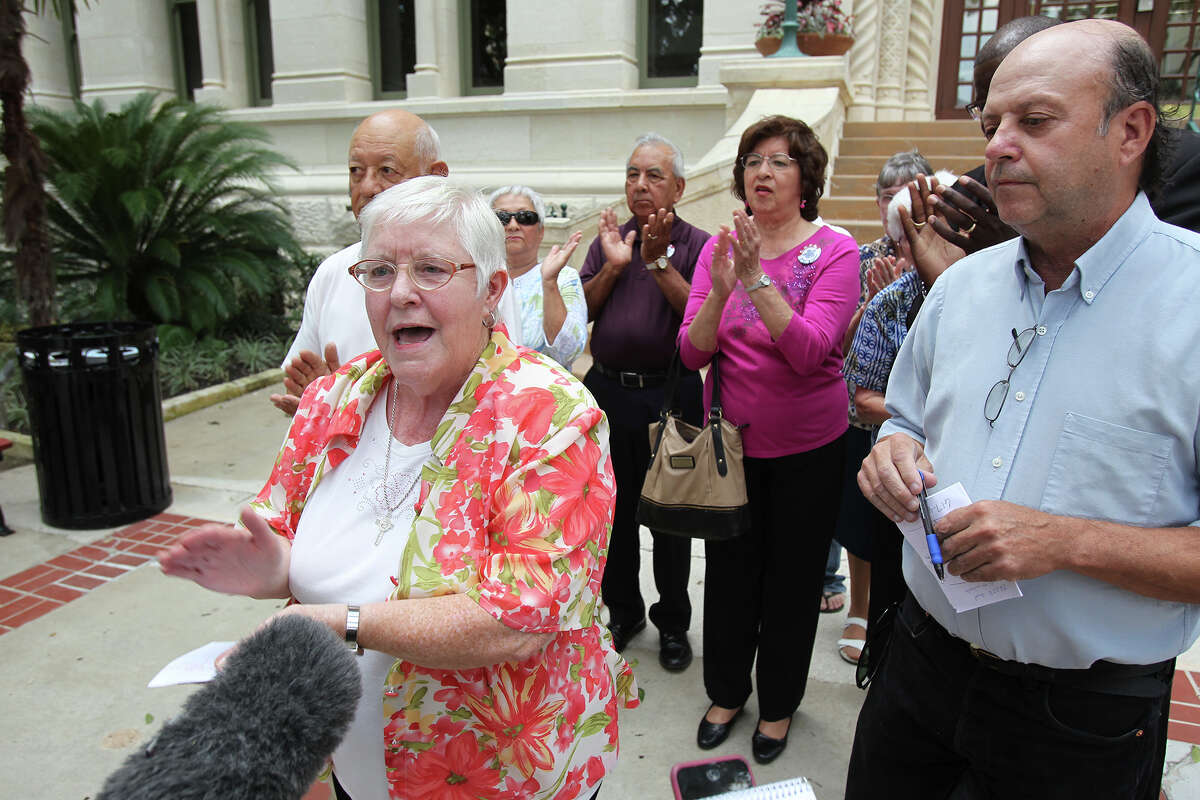 Sister Gabriella Lohan leads applause as members of COPS and METRO gather at City Hall to express their approval of a proposed hike in the minimum wage for San Antonio on July 31, 2015.