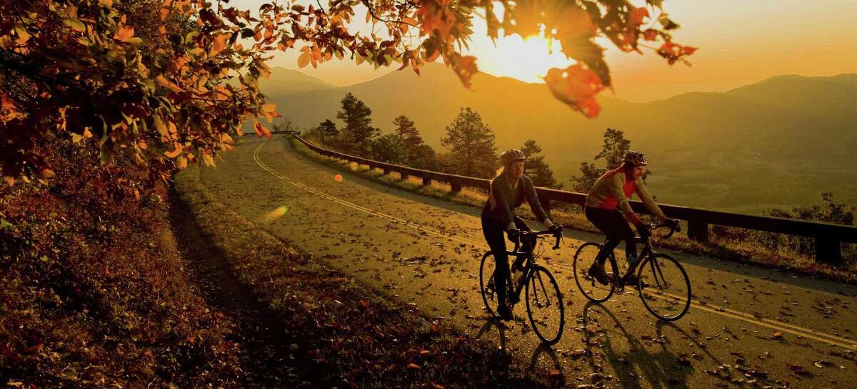 Autumn bike riders travel along the Blue Ridge Parkway near Peaks of Otter, Va.