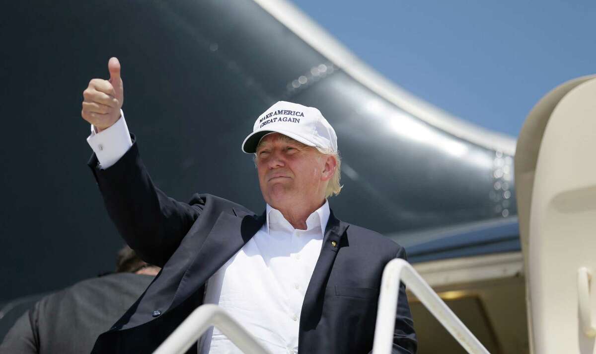 Republican presidential hopeful Donald Trump gives a thumbs up before boarding his campaign plane to depart from Laredo on July 23. He said Hispanics will love him as president.