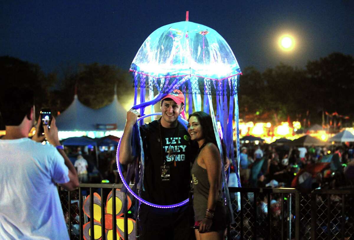 Rachael Hyjek and Corey DeSalvo, both from NYC, pose for a photo with the full moon in the background while at the Gathering of the Vibes at Seaside Park in Bridgeport, Conn., on Friday July 31, 2015. Snapping the photo is John Costello, of Kings Park, Long Island.