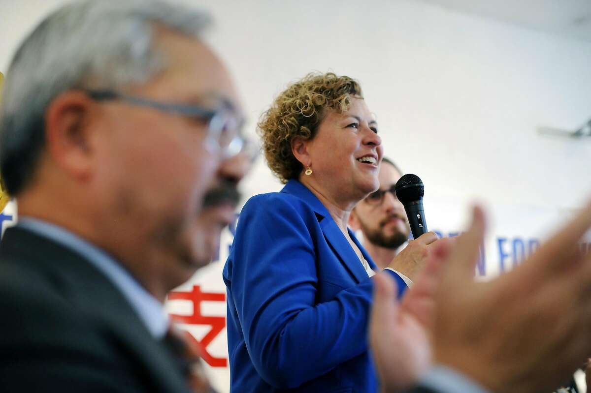 Mayor Ed Lee, left, claps as supervisor Julie Christensen speaks to the crowd during a kick-off celebration for Christensen's re-election campaign in San Francisco on Aug. 1, 2015.
