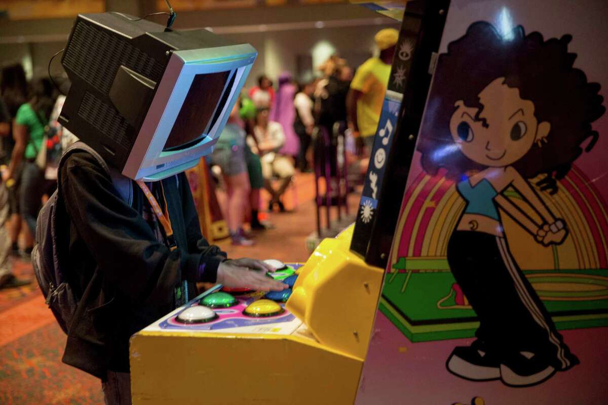 A San Japan attendee plays the Pop'n Music arcade game at San Japan in San Antonio, Texas.