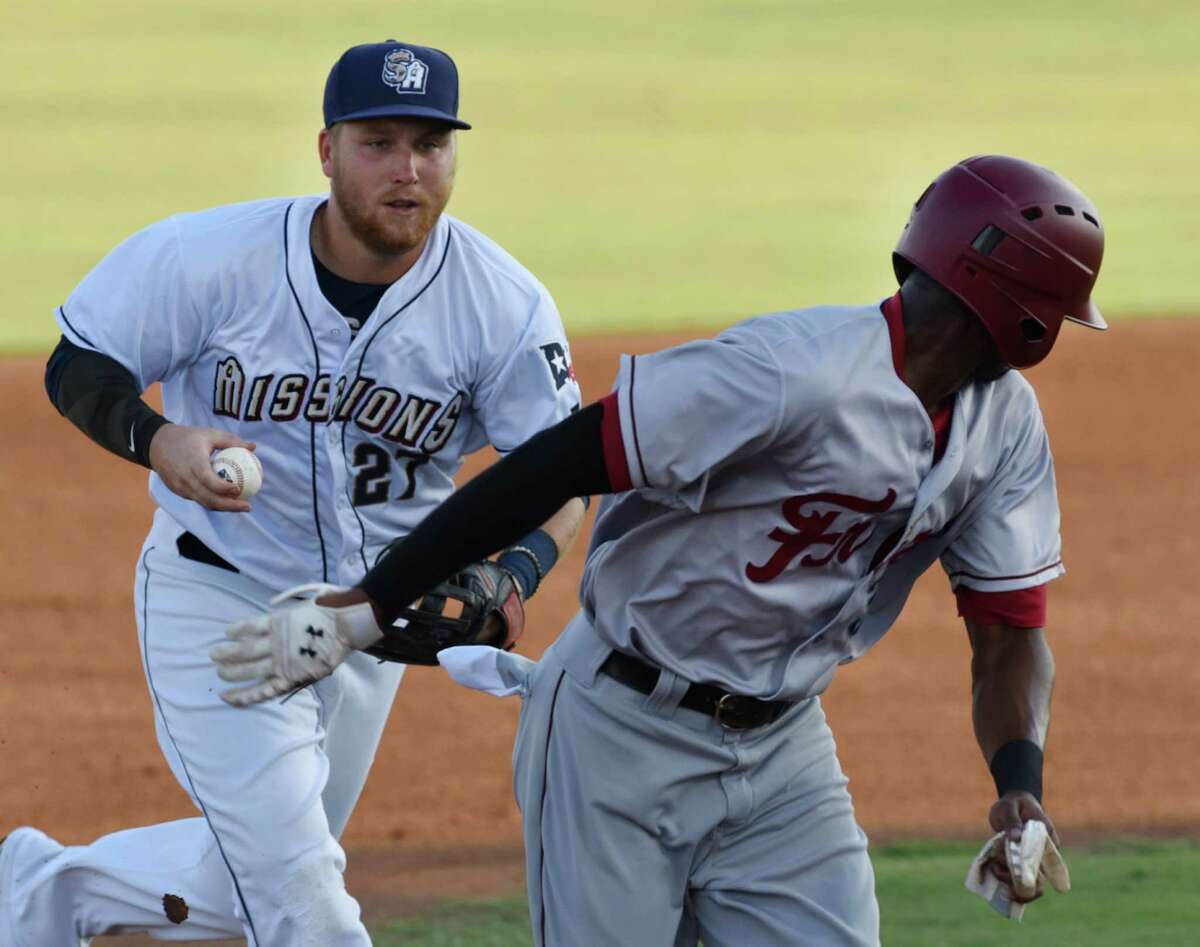 San Antonio Missions second baseman Taylor Lindsey chases Frisco RoughRiders runner Lewis Brinson in a rundown during Texas League action at Wolff Stadium on Aug. 1, 2015.