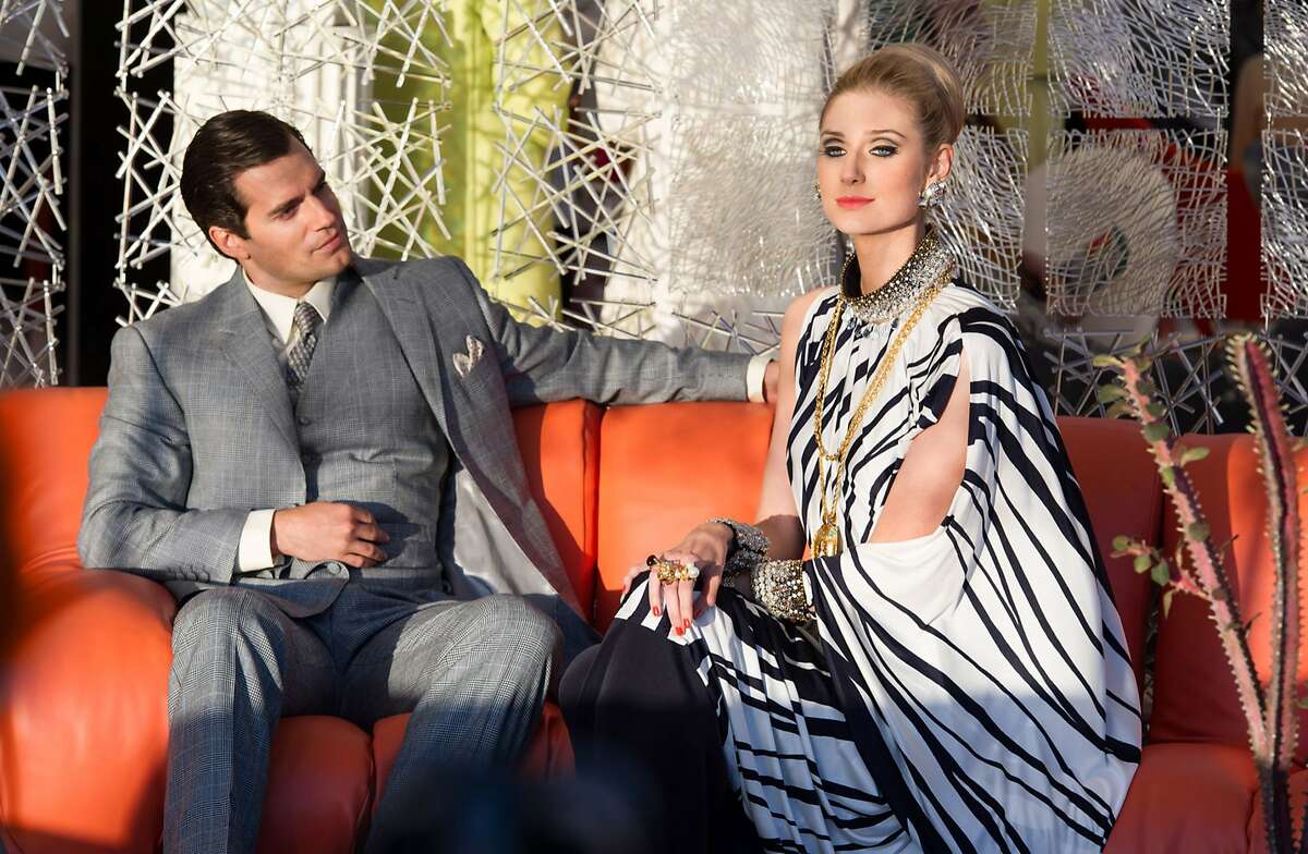 This photo provided by Warner Bros. Pictures shows, Henry Cavill, left, as Napoleon Solo, and Elizabeth Debicki as Victoria in Warner Bros. Pictures' action adventure “The Man from U.N.C.L.E.,” a Warner Bros. Pictures release. The movie, directed by Guy Ritchie, opens in U.S. theaters on Aug. 14. (Daniel Smith/Warner Bros. Pictures via AP)