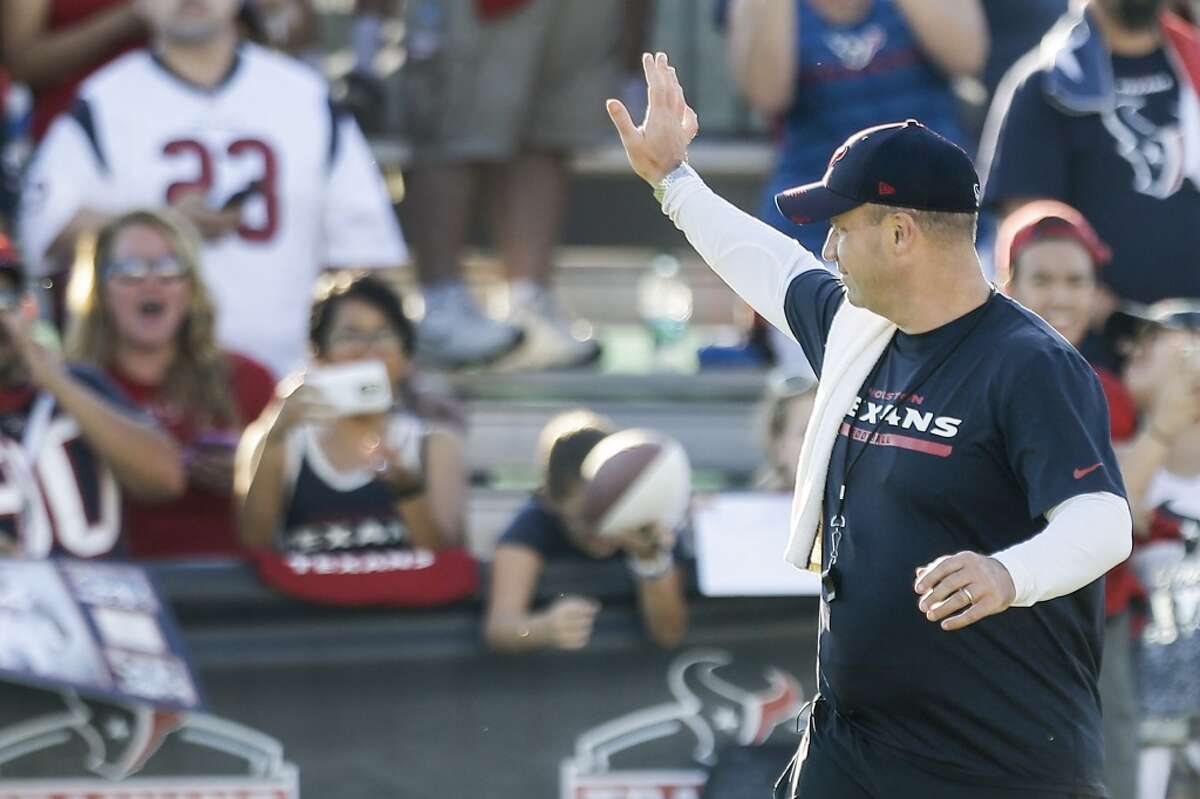 Houston Texans head coach Bill O'Brien waves to the fans as he walks onto the practice field during Texans training camp at the Methodist Training Center Sunday, Aug. 2, 2015, in Houston. ( Brett Coomer / Houston Chronicle )