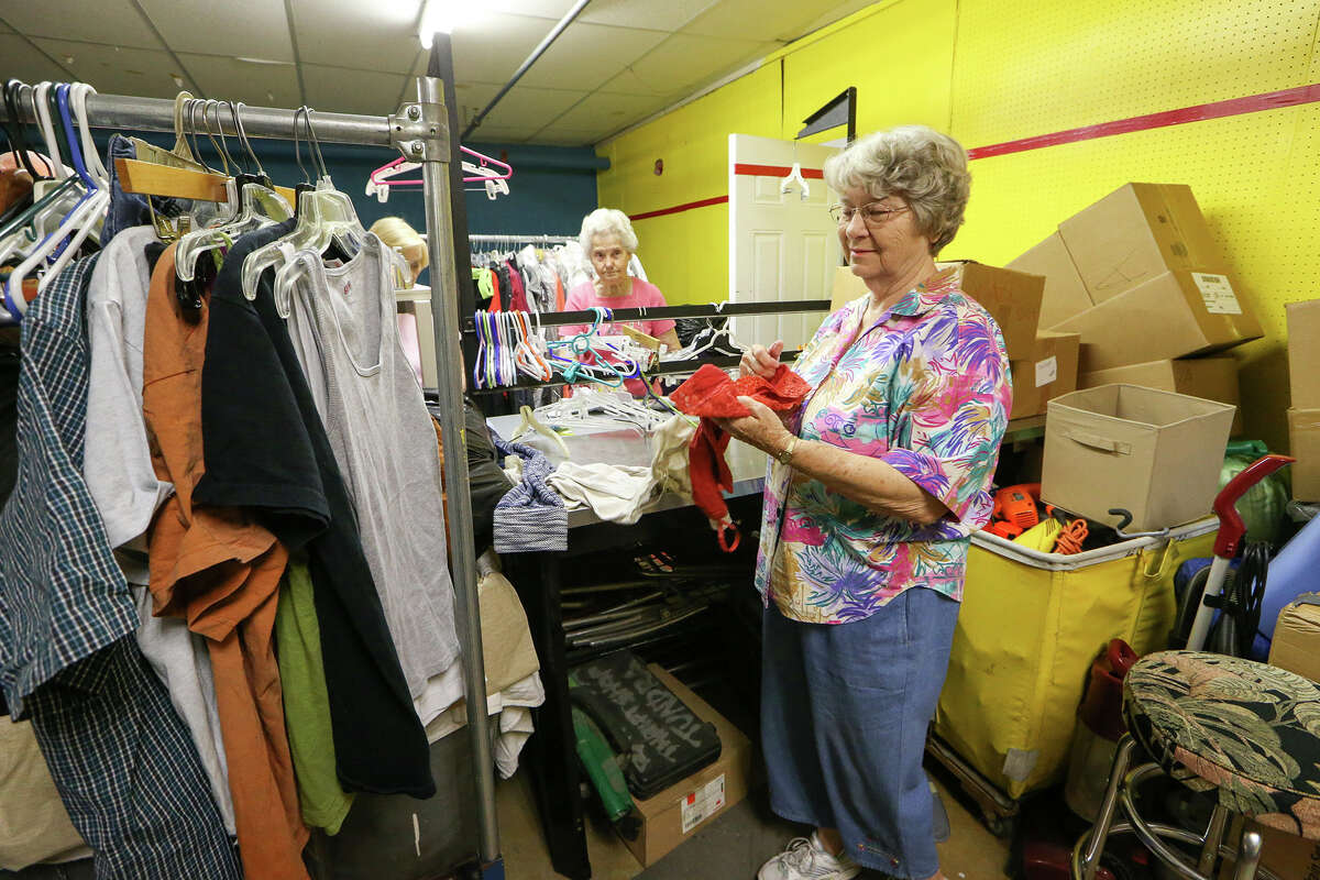 Martha Clark (from right), Catherine Hohmann and Irene Lamprecht sort donated clothing at the Roy Maas Youth Alternatives Thrift Shop on Monday, July 27, 2015.