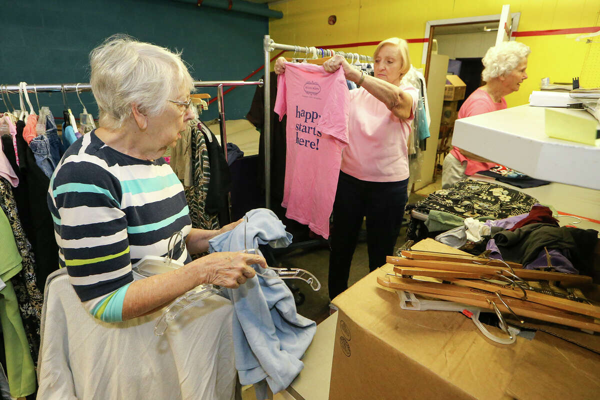 Peg Courtney (from left), Irene Lamprecht and Catherine Hohmann sort donated clothing at the Roy Maas Youth Alternatives Thrift Shop on Monday, July 27, 2015.