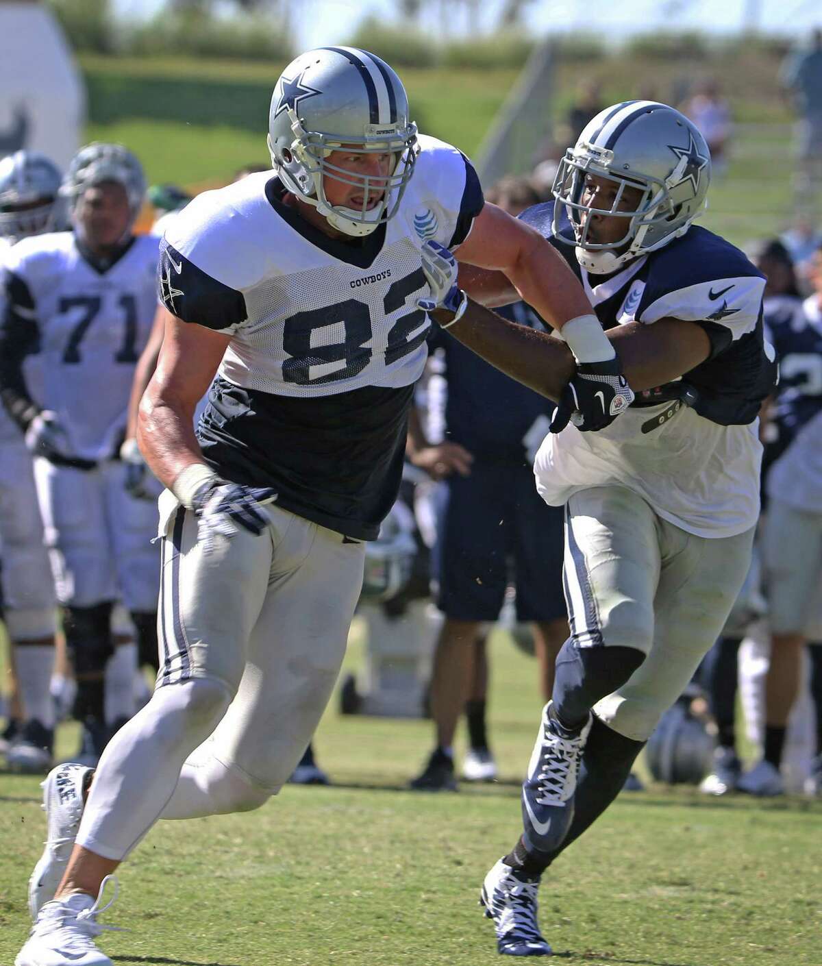 Dallas Cowboys tight end Jason Witten (82) cuts around strong safety Barry Church (42) during afternoon practic e at training camp in Oxnard, Calif., on Saturday, Aug. 1, 2015.