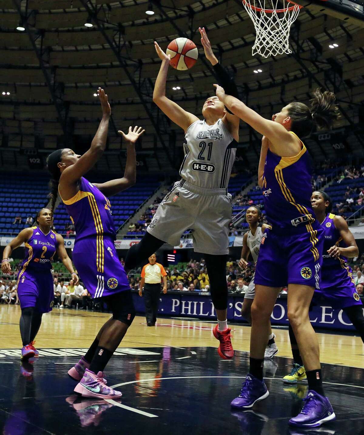 San Antonio Stars’ Kayla McBride grabs for a rebound between Los Angeles Sparks’ Jantel Lavender (left) and Marianna Tolo during first half action Sunday Aug. 2, 2015 at the Freeman Coliseum.