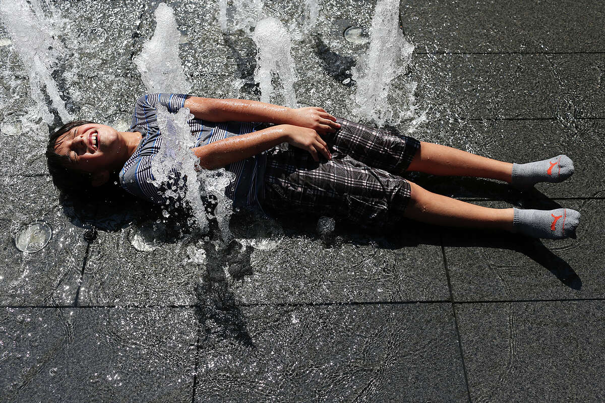 Octavio Barrientos, 8, cools off with the fountains at Main Plaza, Sunday, August 2, 2015. Temperatures reached the high 90's during the afternoon with lows in the 70's at night. The pattern is expected to continue through the week.