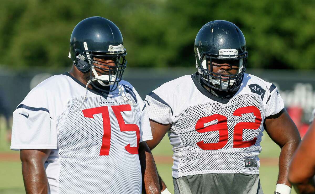Houston Texans defensive tackle Vince Wilfork (75) and defensive tackle Louis Nix III (92) listen to instructions during NFL football training camp at the Methodist Training Center on Sunday, Aug. 2, 2015, in Houston. (AP Photo/Bob Levey)