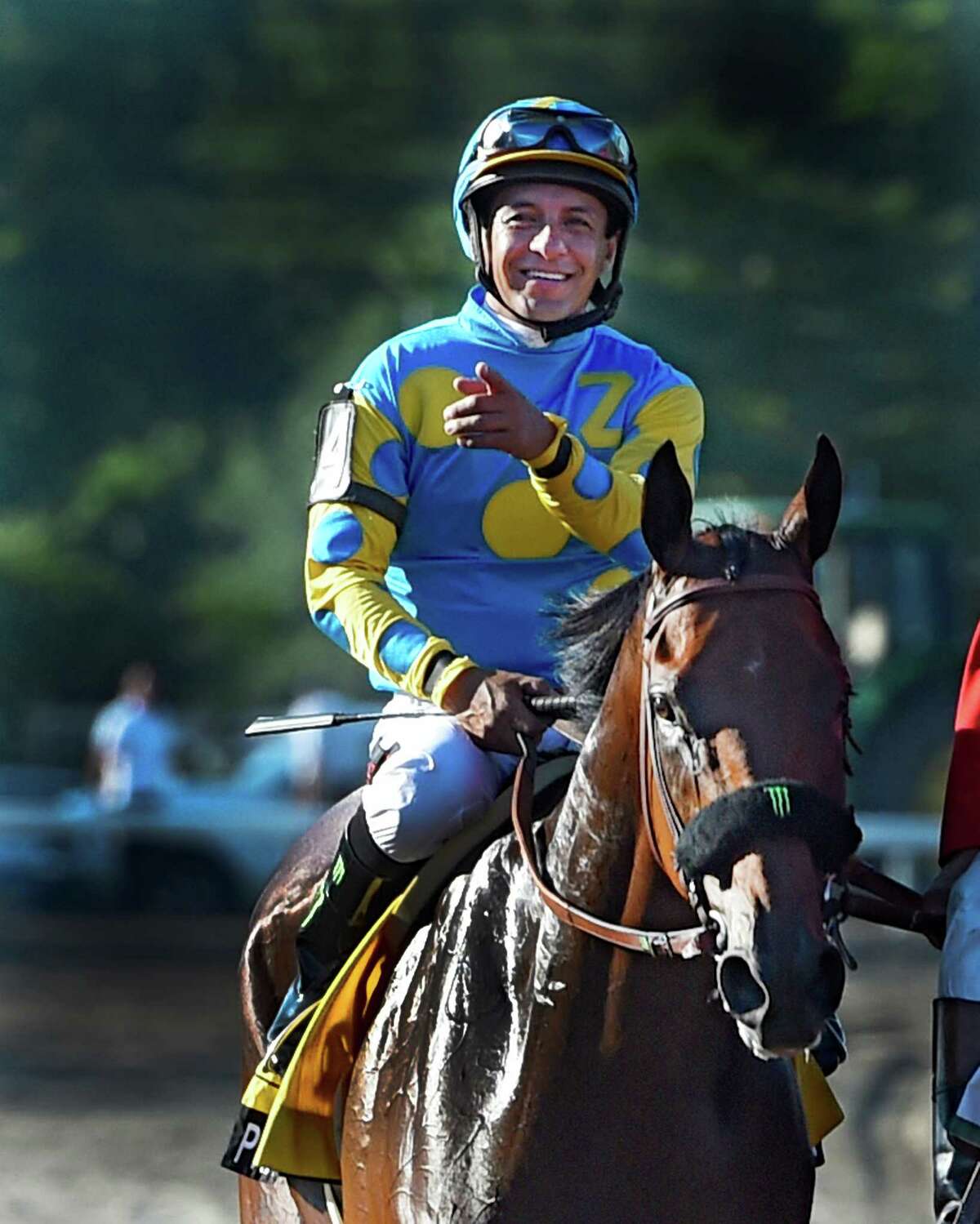 Jockey Victor Espinoza is jubilant Sunday Aug. 2, 2015 at Monmouth Park in Oceanport, N.J. after Triple Crown winner American Pharoah's easy win in the 48th running of The Haskel Invitational. (Skip Dickstein/Times Union