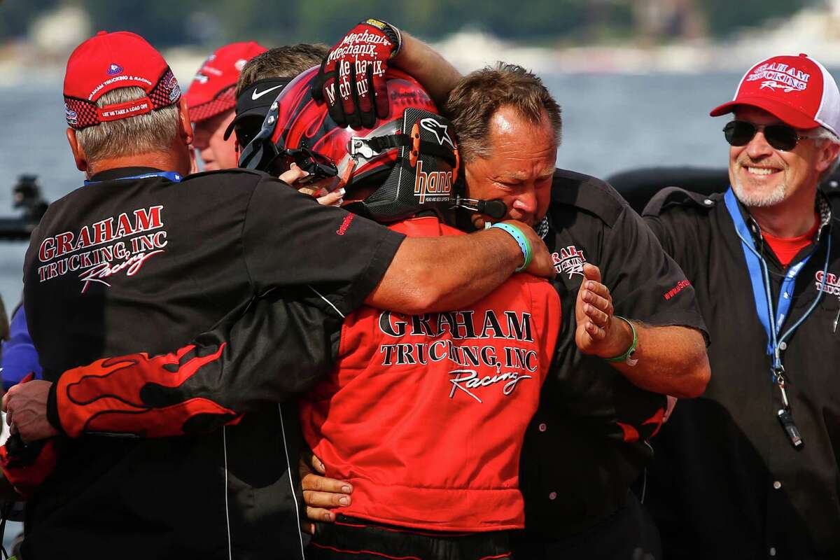 Teammates hug J. Michael Kelly after his win of the Albert Lee Cup at Seafair in the U-5 Graham Trucking during Seafair 2015. Seafair, the traditional summer Seattle festival, brings hydroplane boats to Lake Washington and aircraft to the skies above for the weekend's Boeing Air Show. Photographed on Sunday, August 2, 2015.